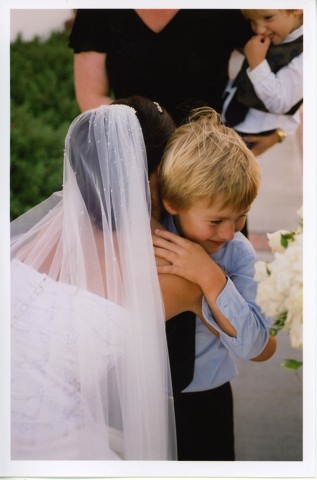boy hugging bride
